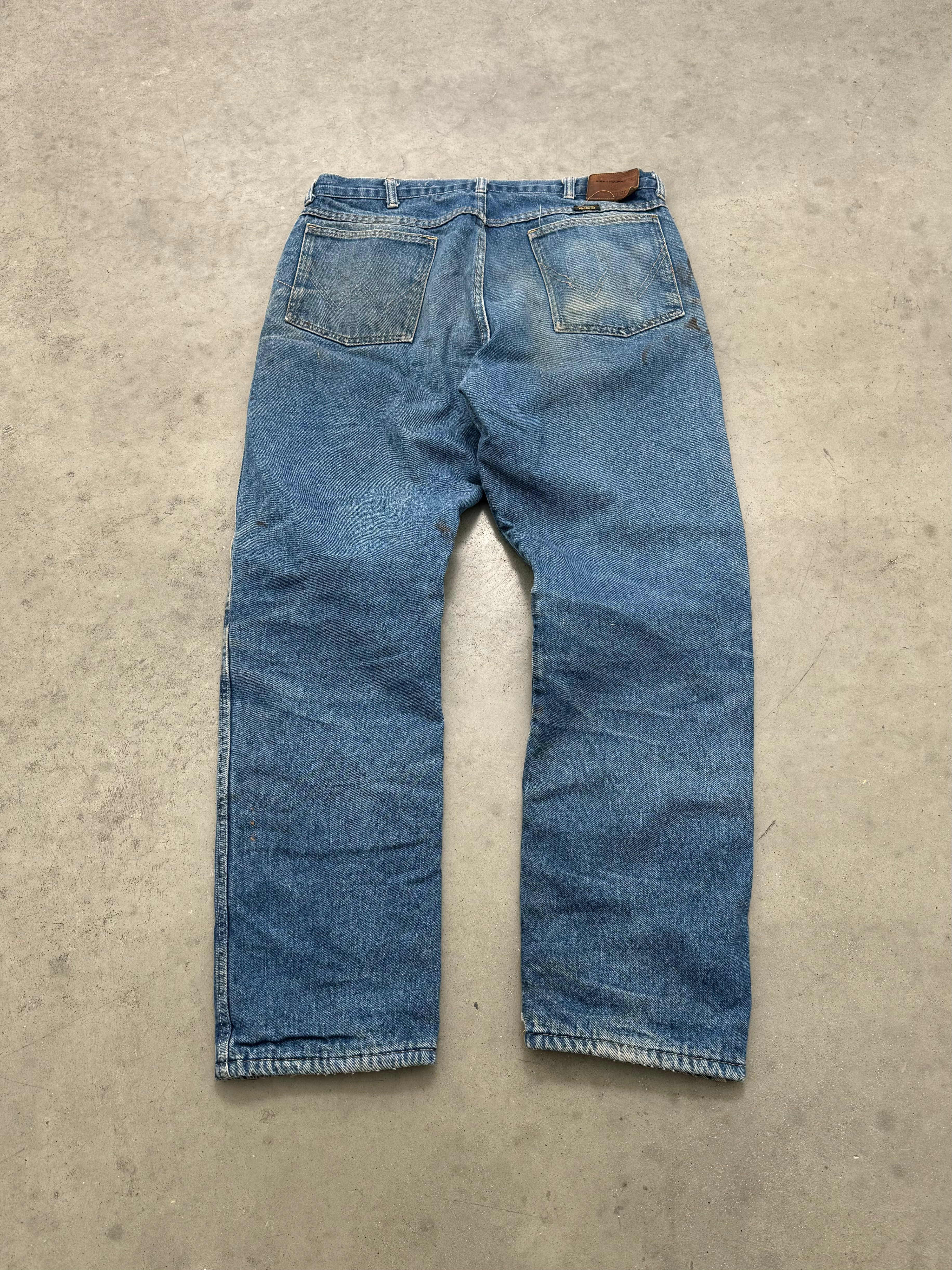 FADED & DISTRESSED RED FLANNEL LINED WRANGLER DENIM - 1980S